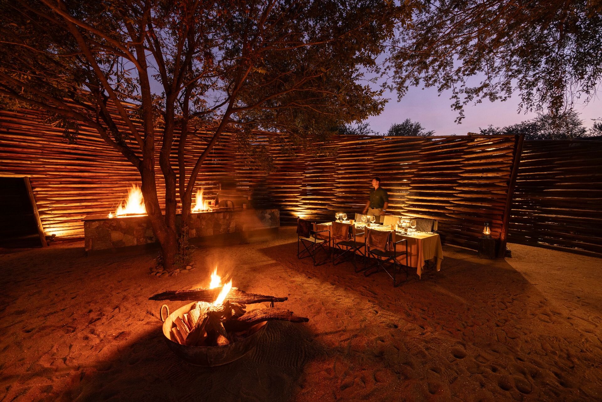 Outdoor fire-lit dining at Tanda Tula safari lodge